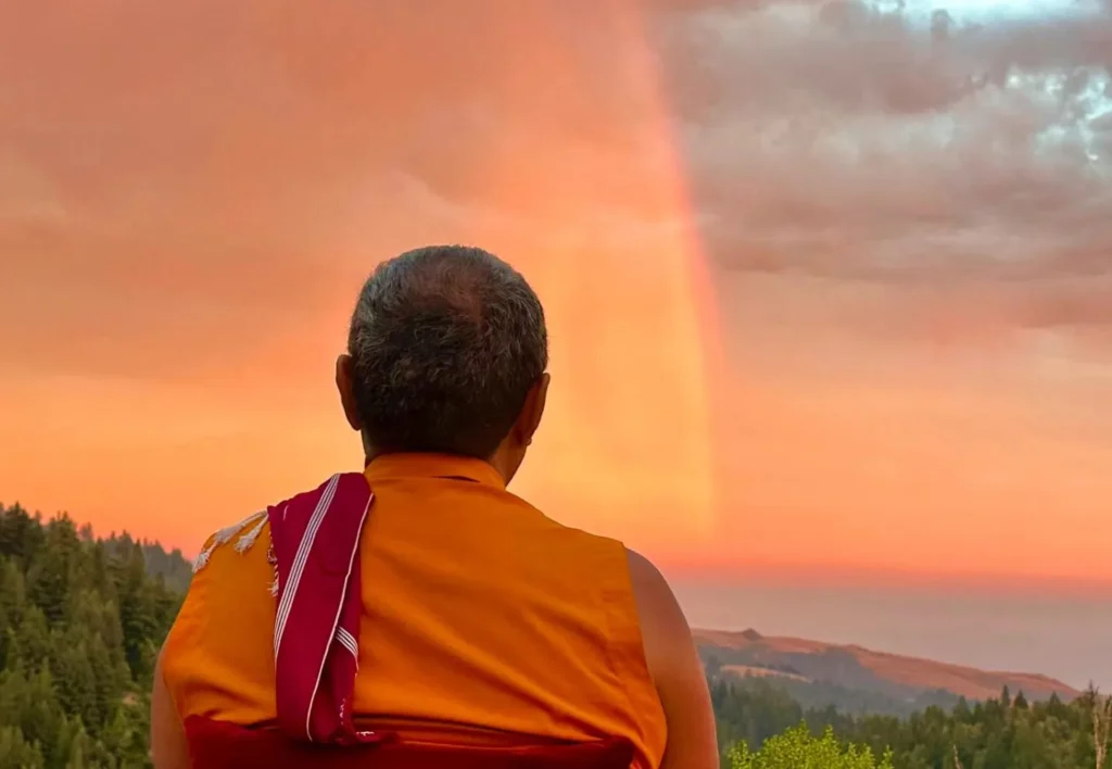 Tromge Jigme Rinpoche meditating in the upper meadow at PPI